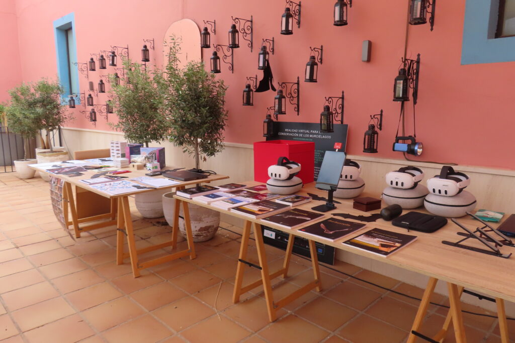 Table with items on it such as flyers and VR glasses
